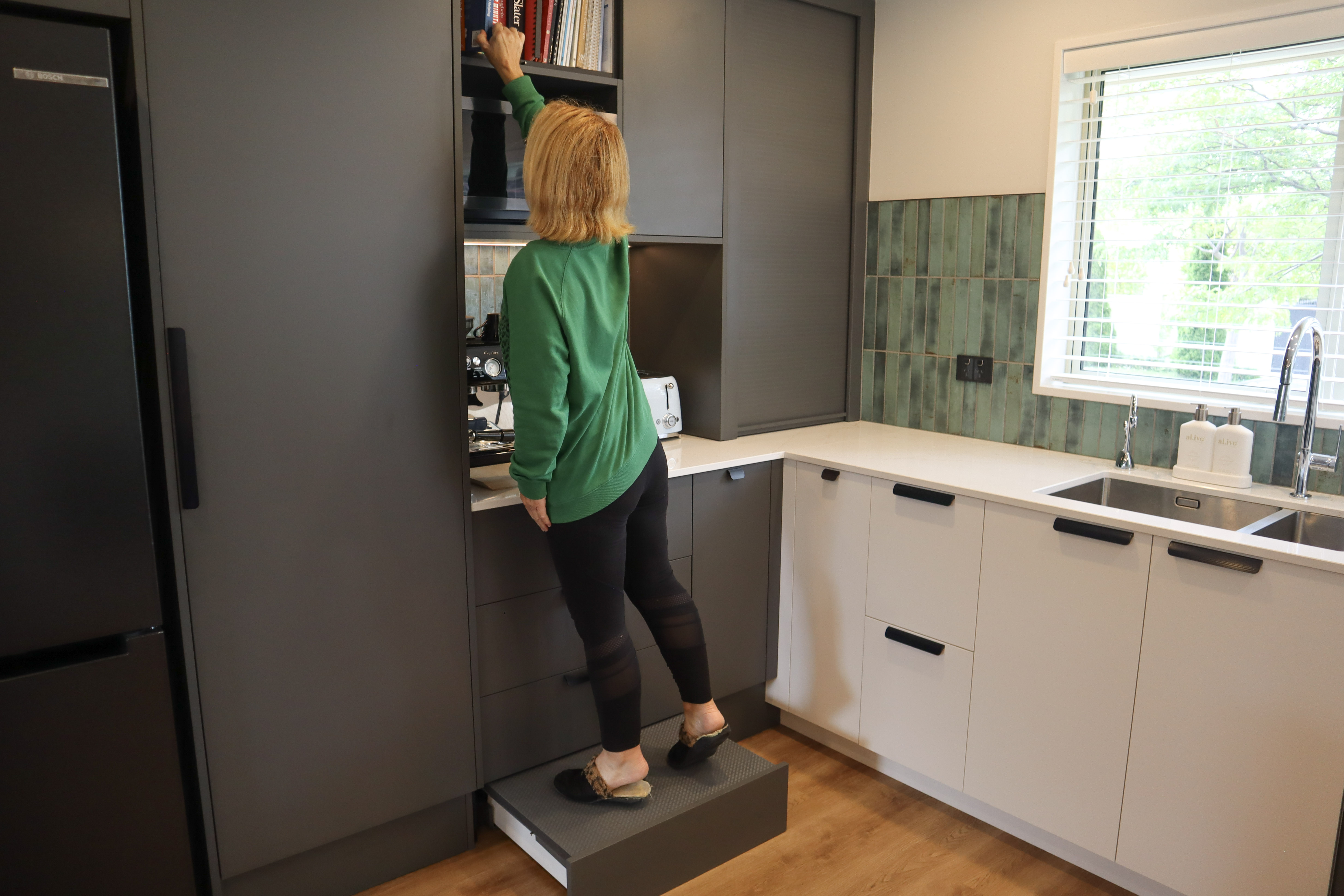 women standing on kitchen built in step